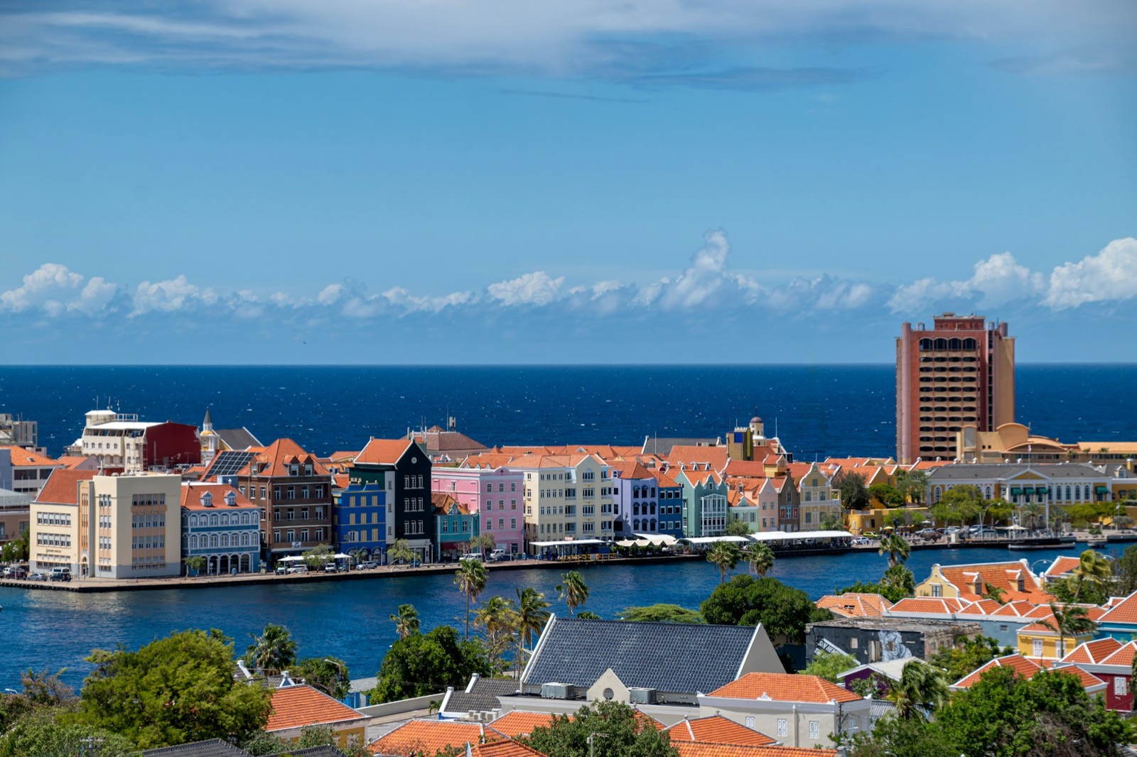 Aerial view of the colourful Willemstad skyline meeting the deep blue Caribbean Sea